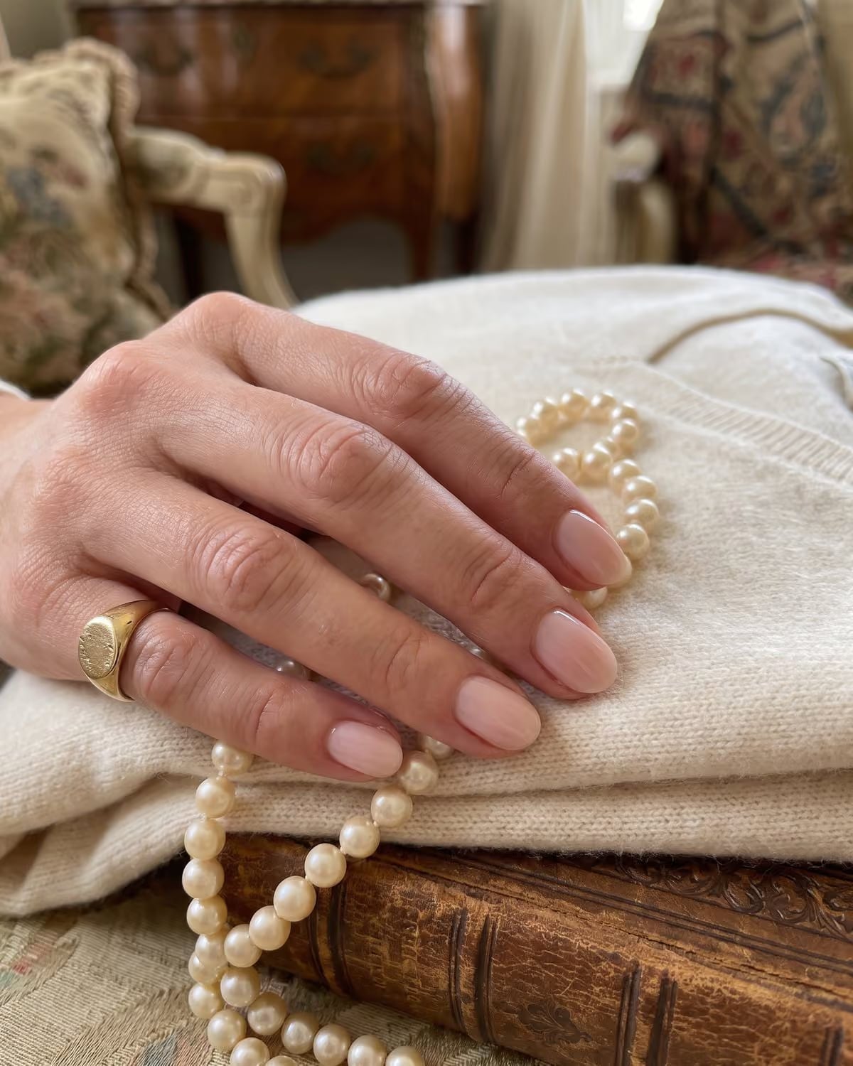 Sheer Milky Pink Nude Short Almond Nails, Holding A Strand Of Pearls Sheer Milky Pink Nude Short Almond Nails, Holding A Strand Of Pearls — Old Money Nails