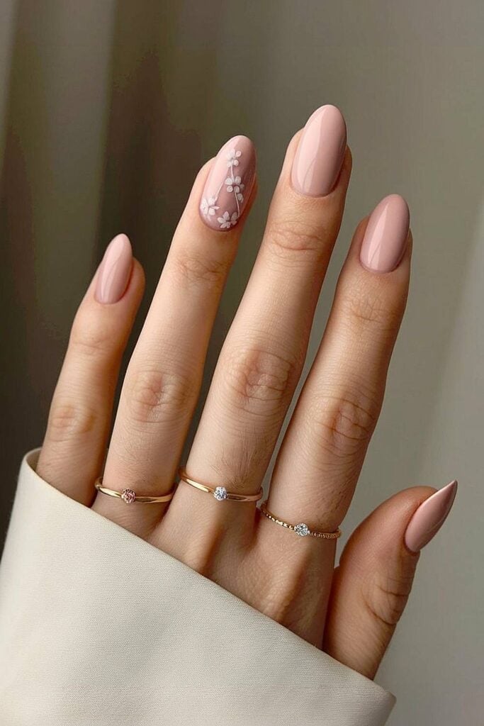 Nude Pink Oval Nails With Floral Art Nude Pink Oval Nails With Floral Art