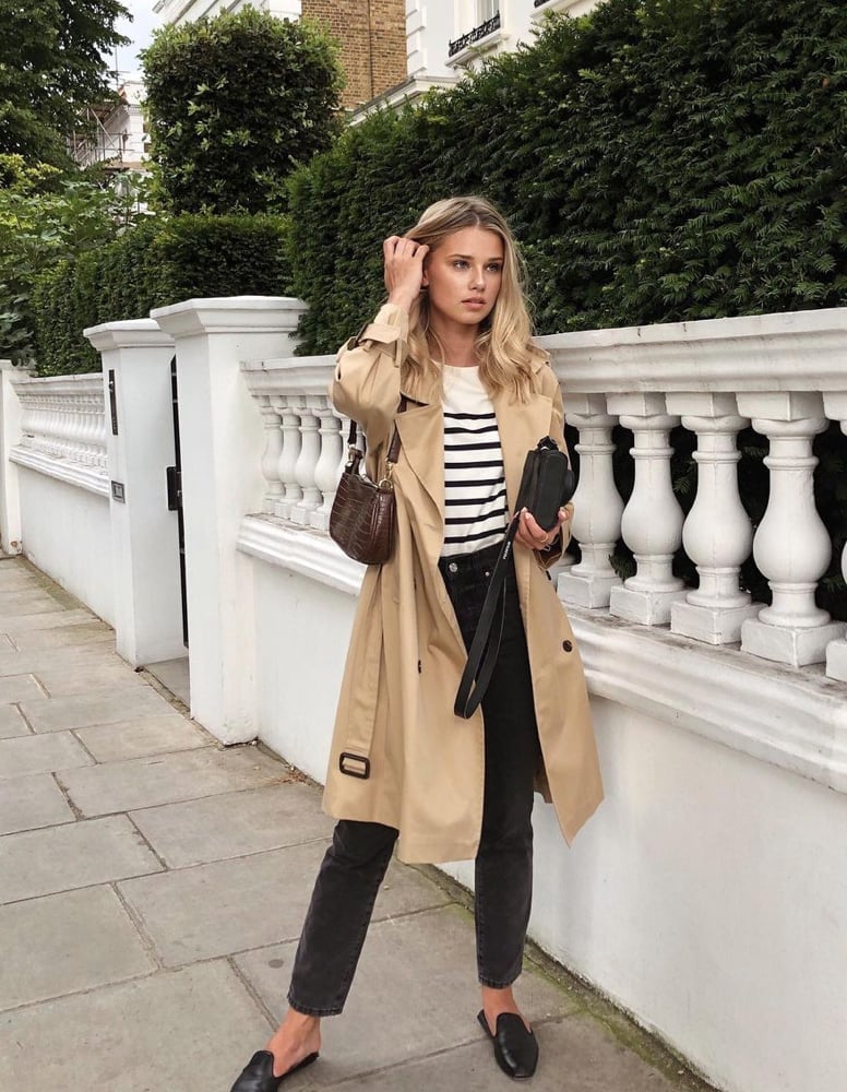 Beige trench coat over striped t-shirt and gray jeans Beige trench coat over striped t-shirt and gray jeans — Parisian Style