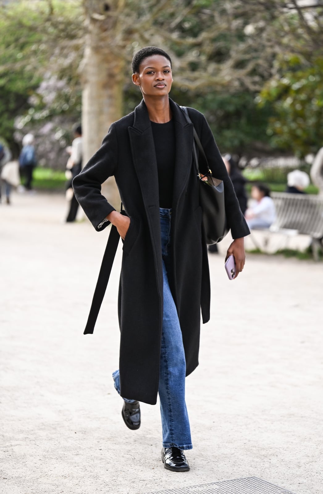 Long black belted wool coat over jeans Long black belted wool coat over jeans — Parisian Style
