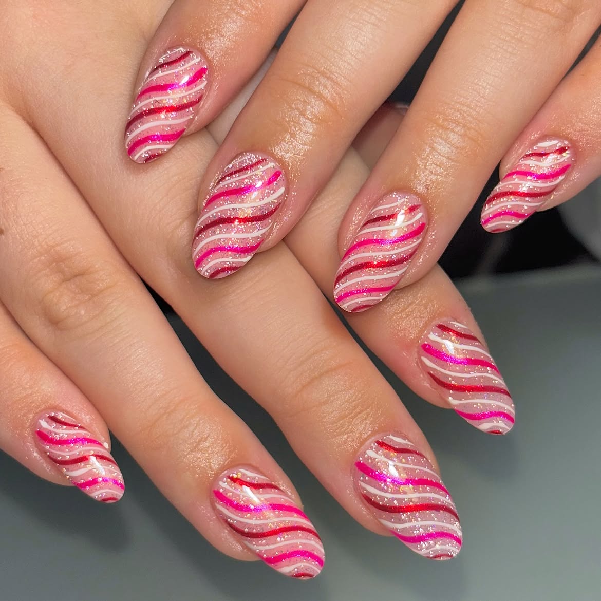 Pink and Red Candy Cane Swirl Almond Nails
