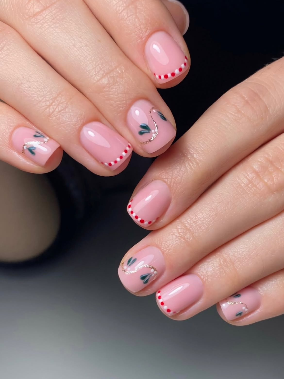 Pink French Tip Nails with Festive Green Accents