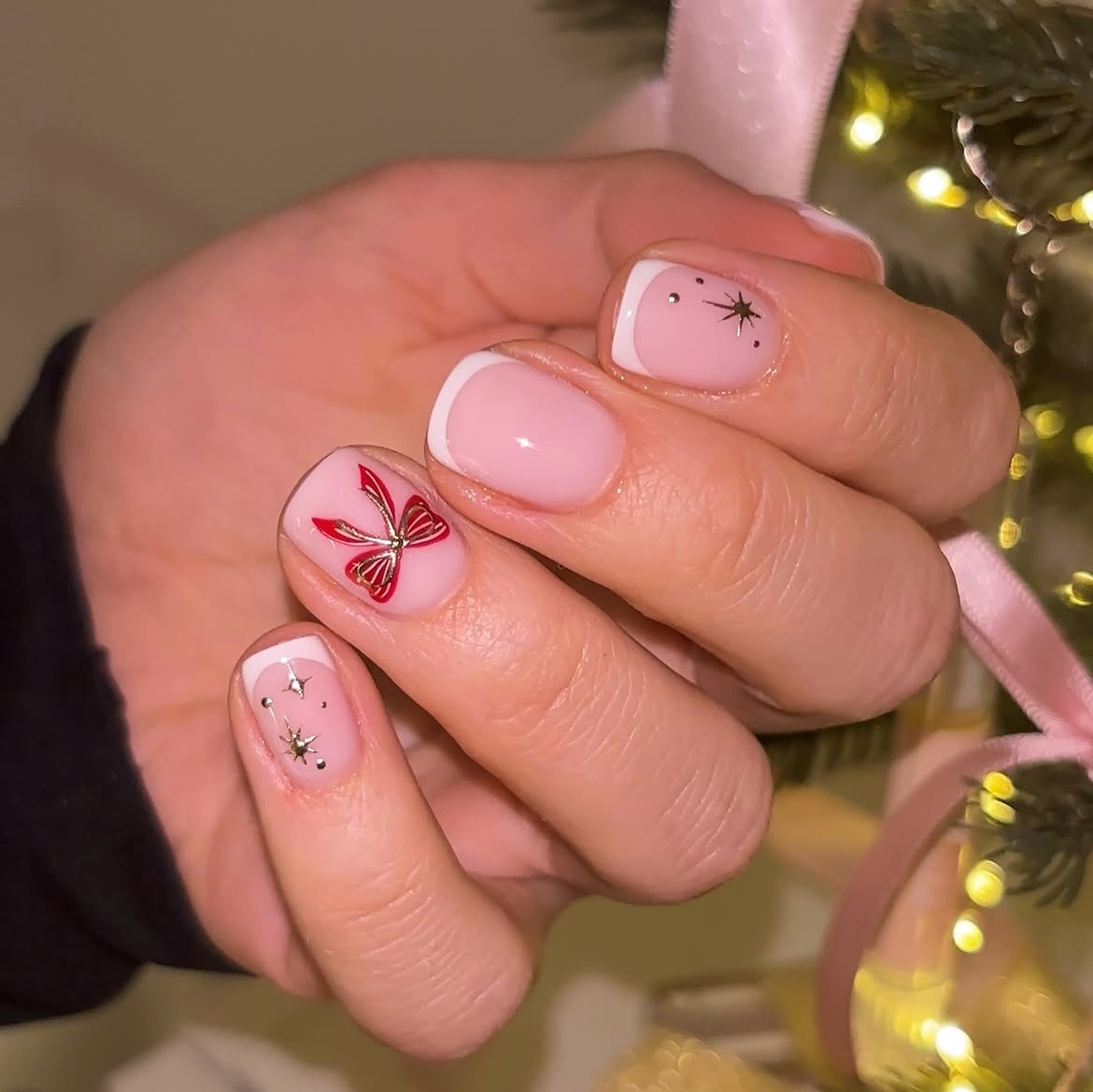 Pink French Tip Nails with Festive Red Bow