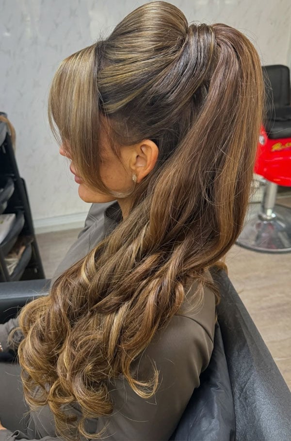 Voluminous Curls Ponytail With Swept Bangs Voluminous Curls Ponytail With Swept Bangs — Ponytail with Bangs