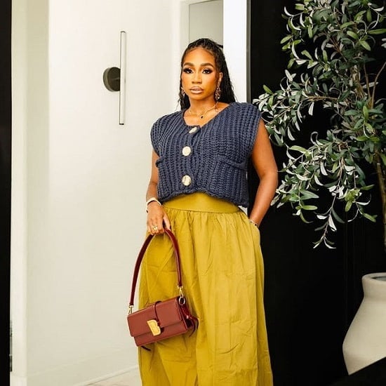 Navy oversized knit vest over wide-leg trousers Navy oversized knit vest over wide-leg trousers — Postpartum Outfits