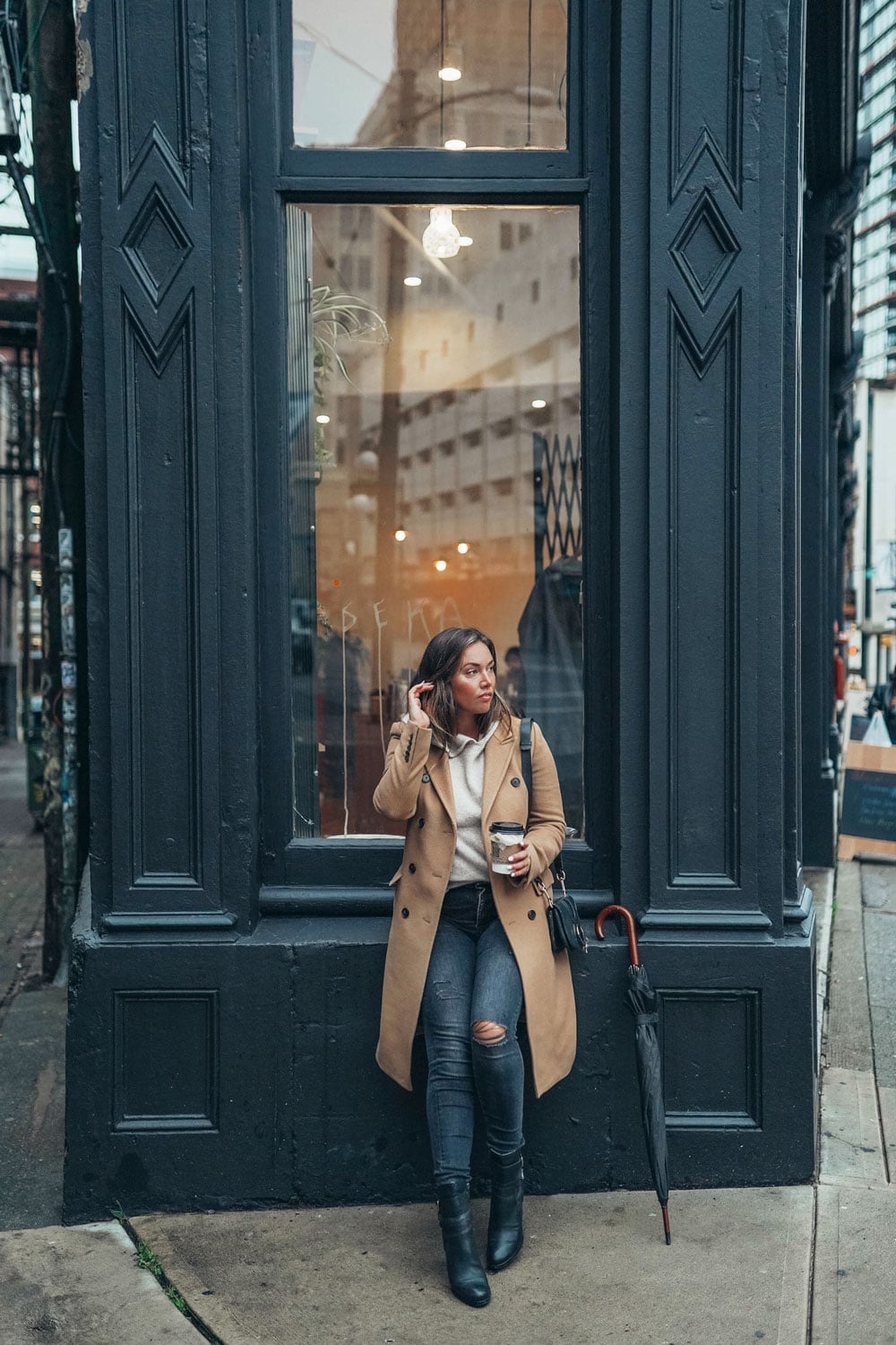 Camel coat over cream hoodie and ripped gray jeans, Black Ankle Boots Camel coat over cream hoodie and ripped gray jeans, Black Ankle Boots — Rainy Day Outfits