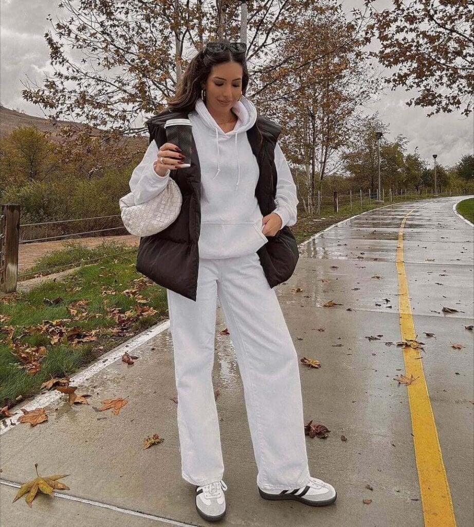Black puffer vest over white hoodie and wide-leg jeans Black puffer vest over white hoodie and wide-leg jeans — Rainy Day Outfits
