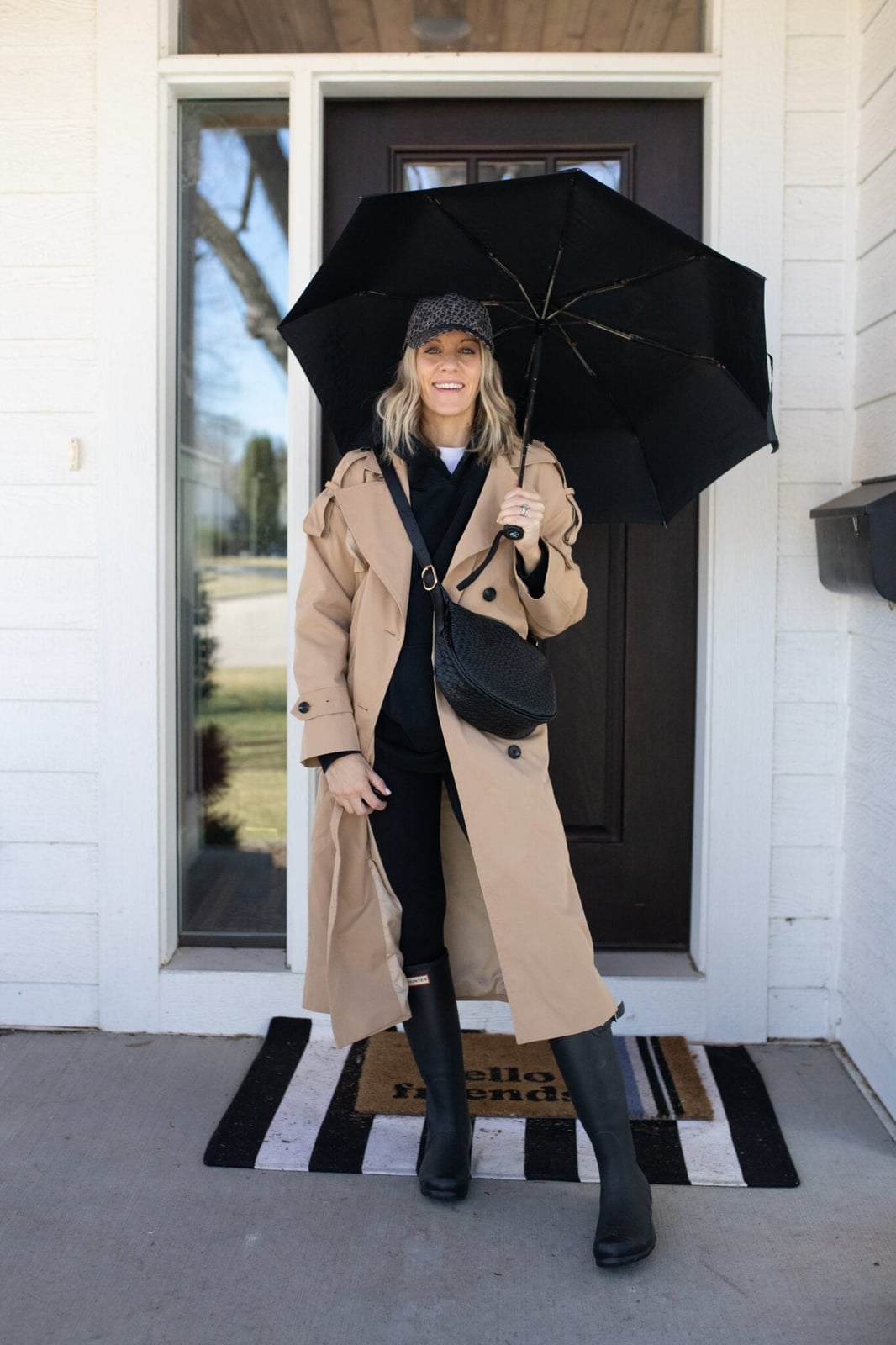 Beige trench coat over gray hoodie and white t-shirt with black Beige trench coat over gray hoodie and white t-shirt with black — Rainy Day Outfits