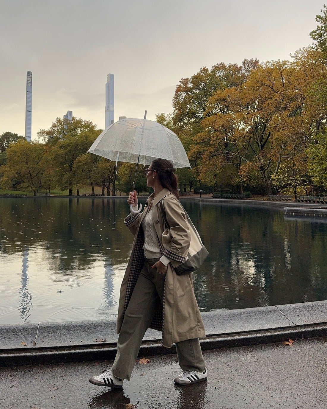 Beige trench coat over white sweater and olive green trousers Beige trench coat over white sweater and olive green trousers — Rainy Day Outfits