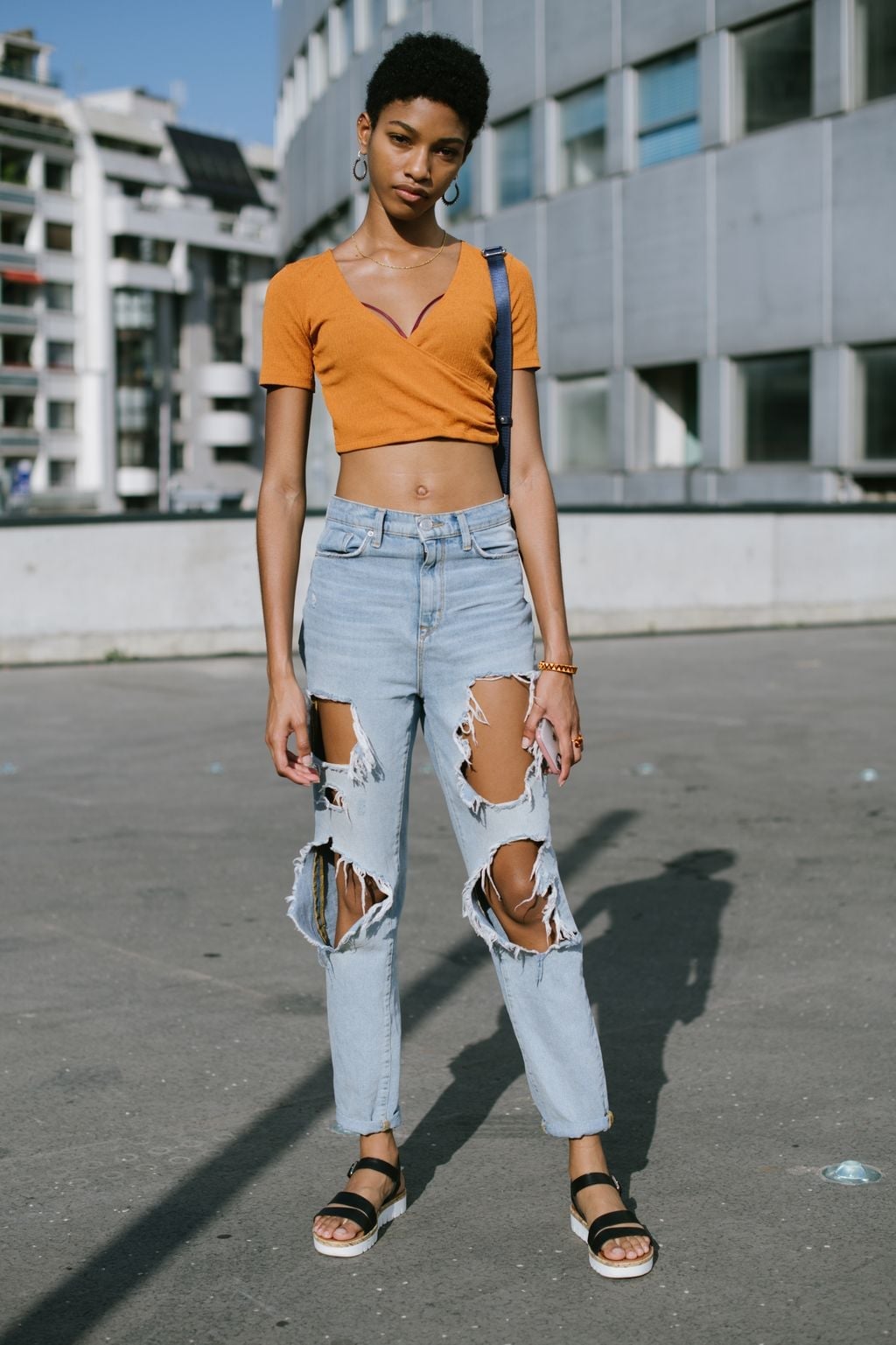 Heavily ripped light blue straight-leg jeans with orange crop top Heavily ripped light blue straight-leg jeans with orange crop top — Ripped Jeans Outfits