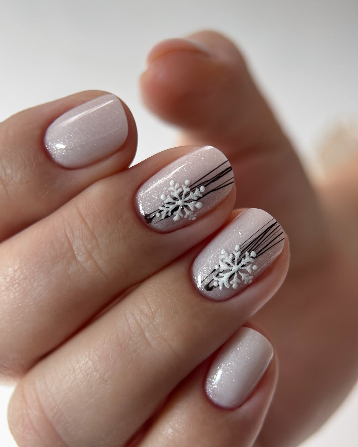 Shimmering Snowflake Nail Art On Short Squoval Nails