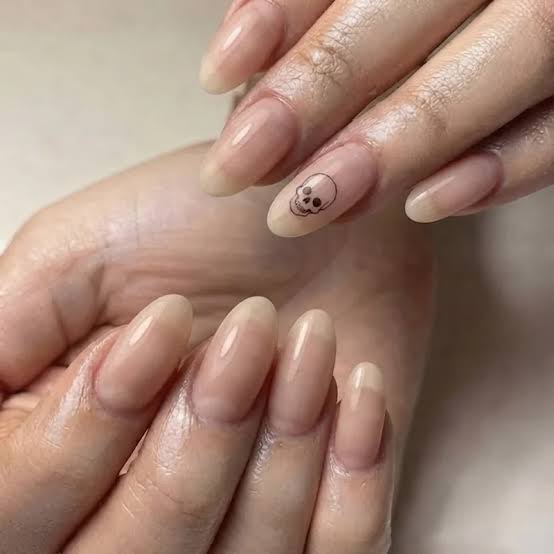 Medium Oval Sheer Nude Minimalist Skull Accent Nail Medium Oval Sheer Nude Minimalist Skull Accent Nail — Skull Nails