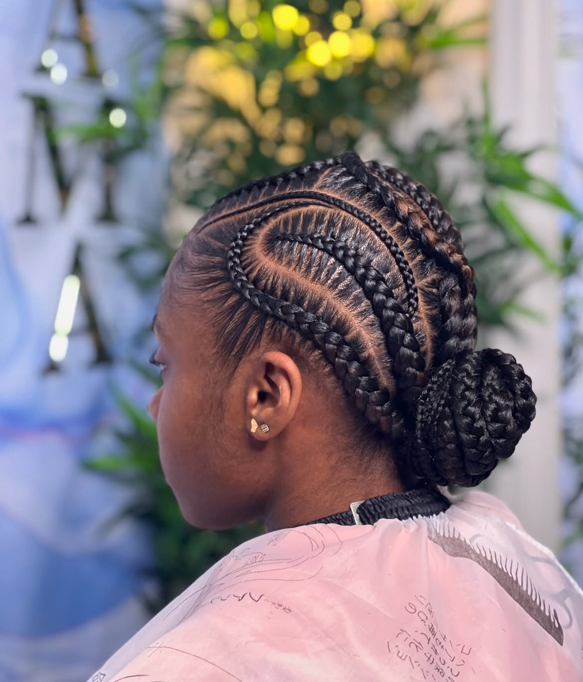 Sleek Cornrow Updo With Neat Curly Bun