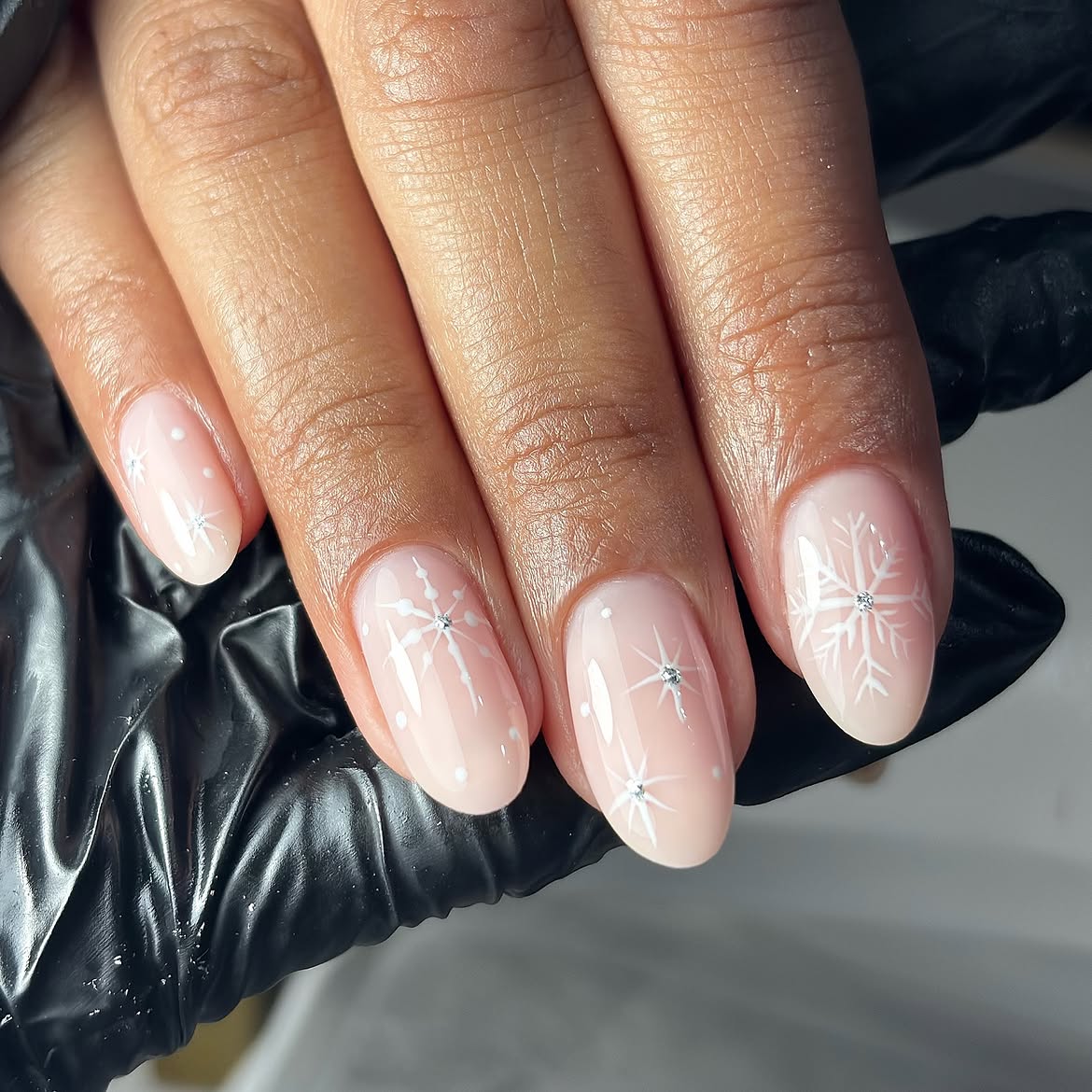 Soft Pink Snowflake Oval Nails with Rhinestone Accents