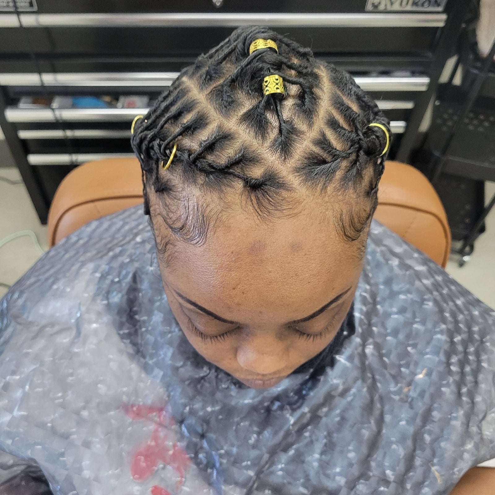 Short Braided Starter Locs with Gold Adornments Short Braided Starter Locs with Gold Adornments