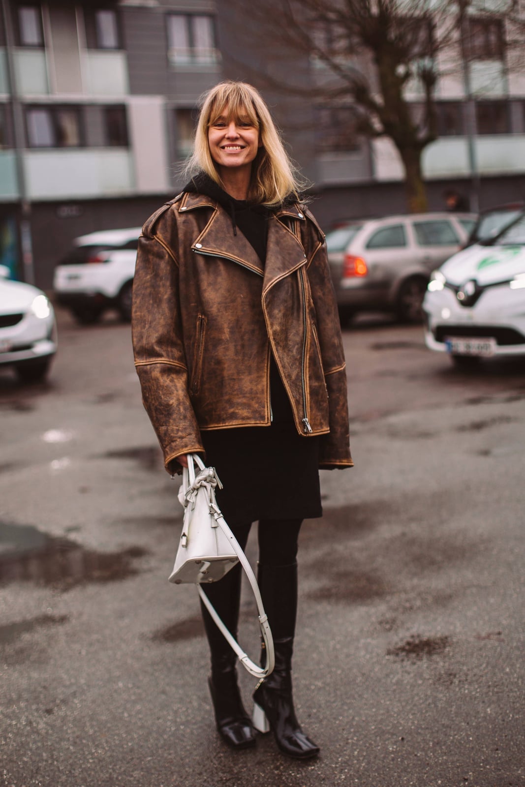 Distressed leather jacket over hoodie and dress Distressed leather jacket over hoodie and dress — Street Style Outfits