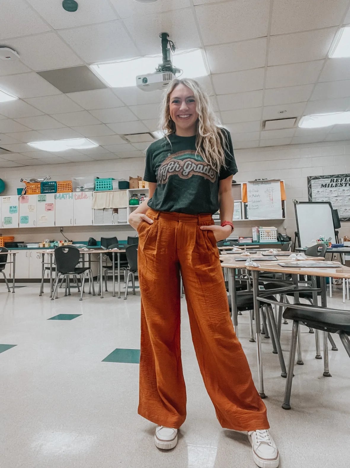 Graphic tee and orange pants in a classroom setting Graphic tee and orange pants in a classroom setting — Teacher Outfits