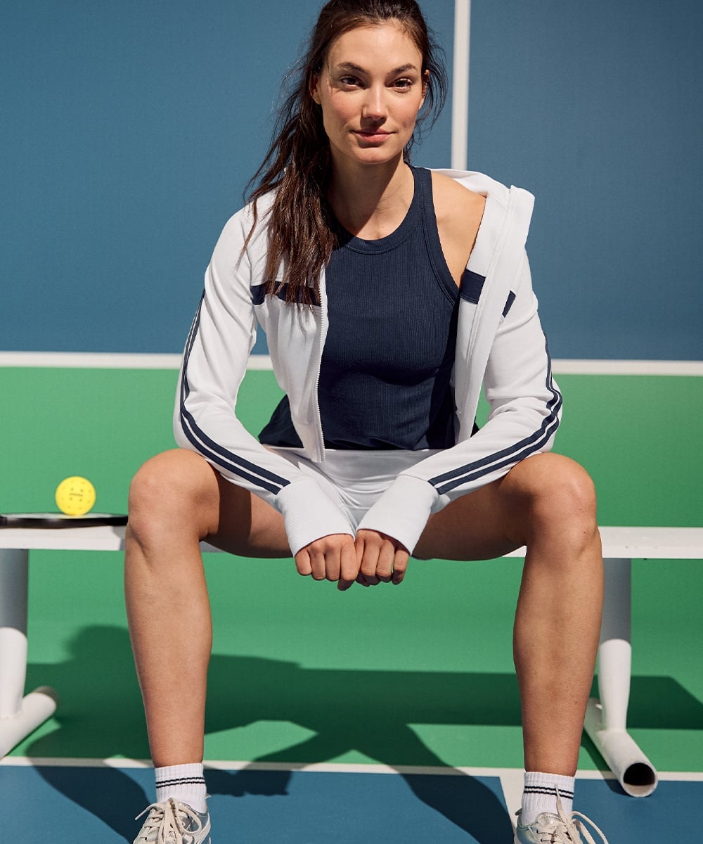 Striped Zip-Up Jacket Over Navy Tank and White Shorts Striped Zip-Up Jacket Over Navy Tank and White Shorts — Tennis Outfits