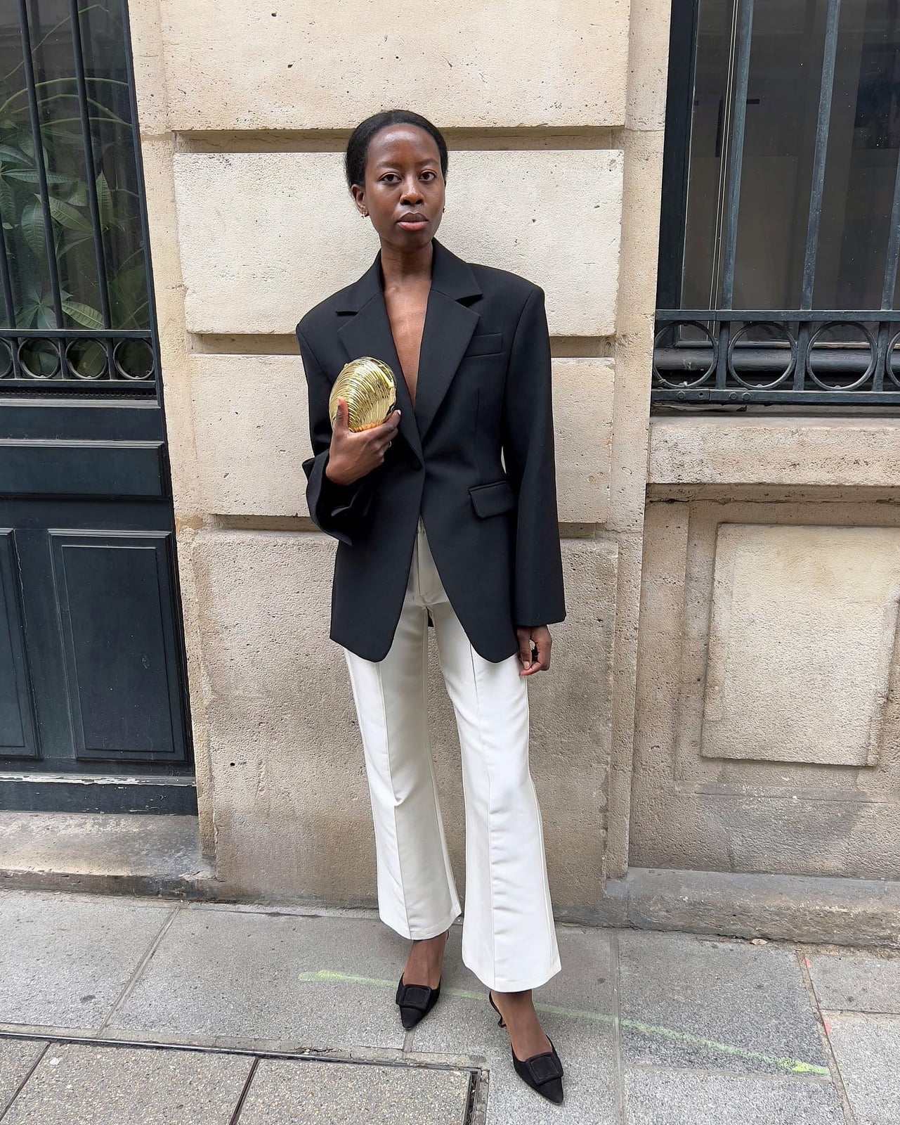 Flared cream trousers offer a sophisticated silhouette Flared cream trousers offer a sophisticated silhouette — Trouser Outfits