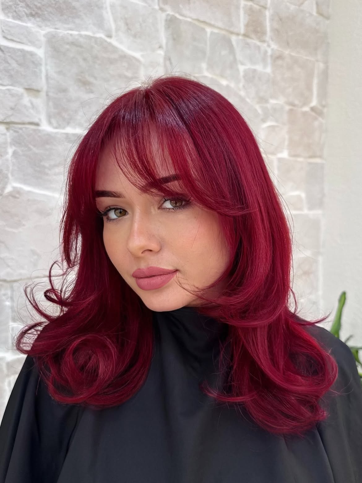 Vibrant Cherry Red Layered Blowout With Wispy Bangs