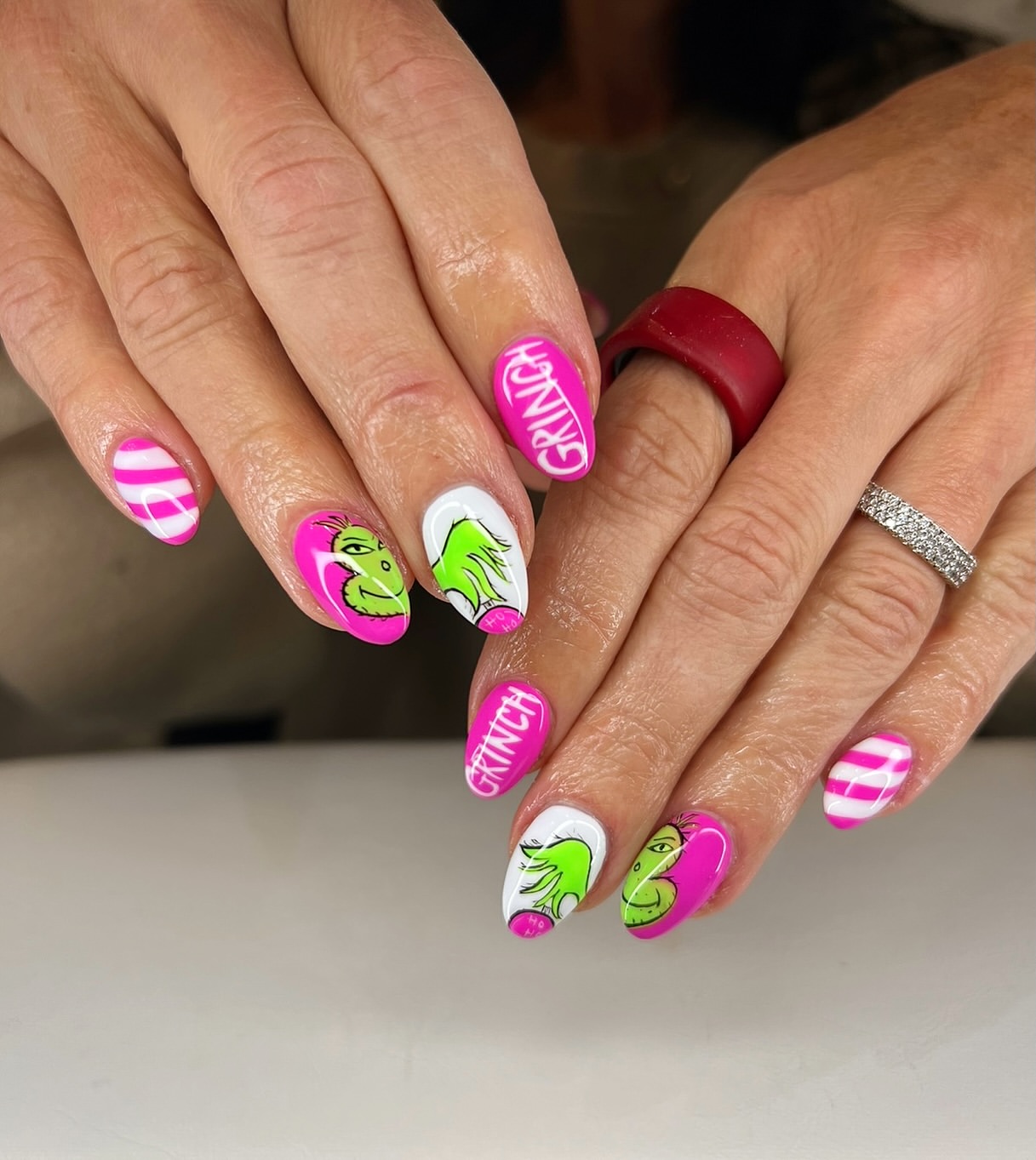 Vibrant Pink And Green Grinch Holiday Almond Nails