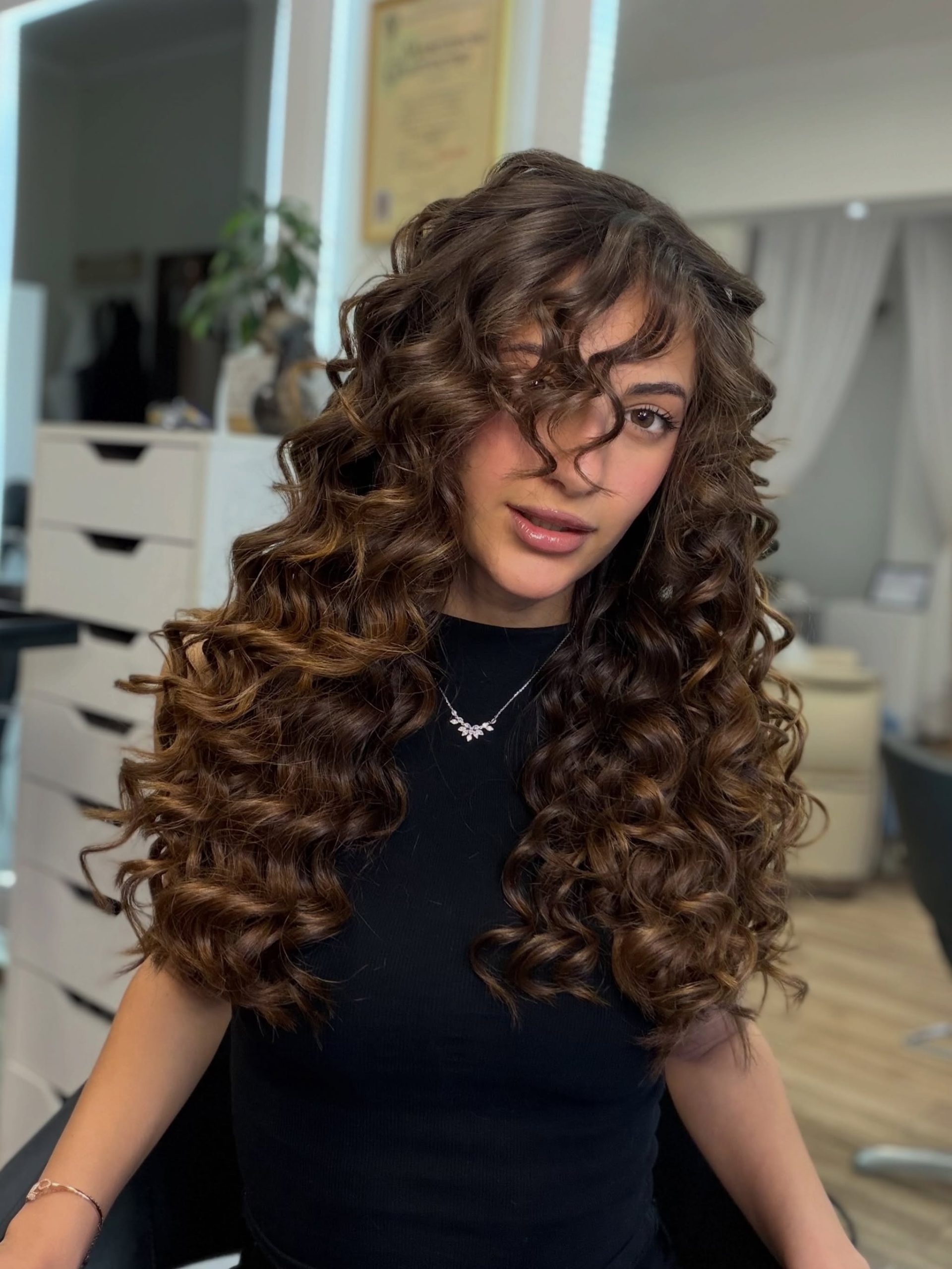 Voluminous Copper-Kissed Curly Lob With Face-Framing Bangs