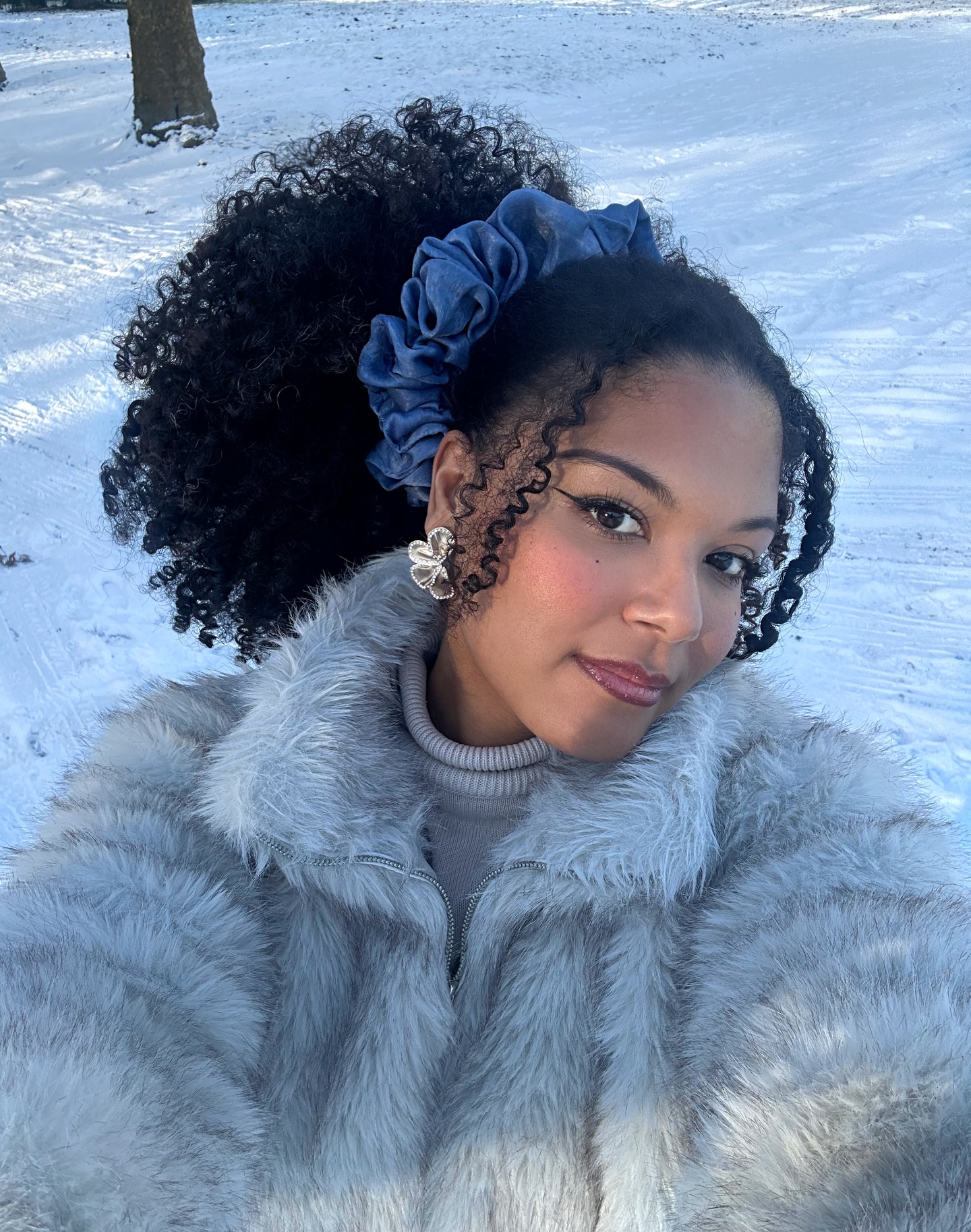 Voluminous Curly High Ponytail With Chic Scrunchie