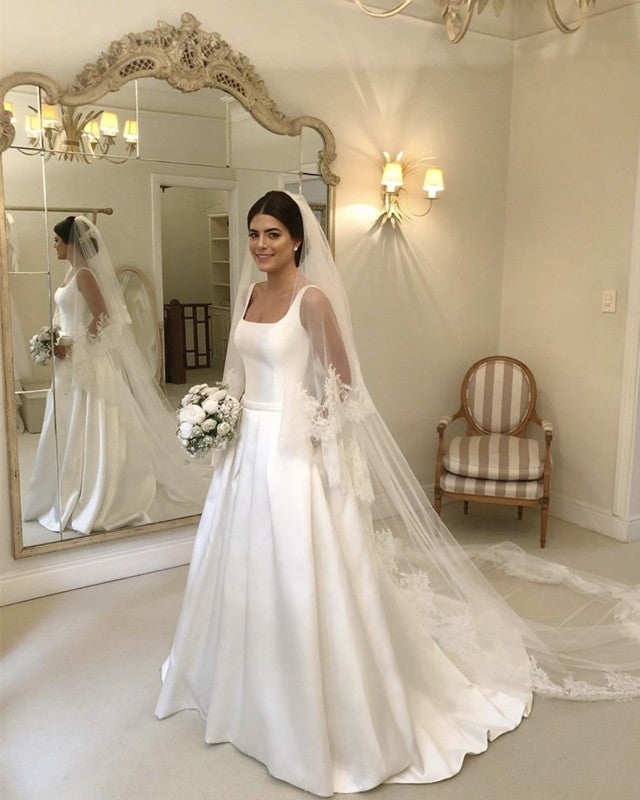 White satin ballgown with square neckline and veil, Close-Up Take White satin ballgown with square neckline and veil, Close-Up Take — Wedding Dress