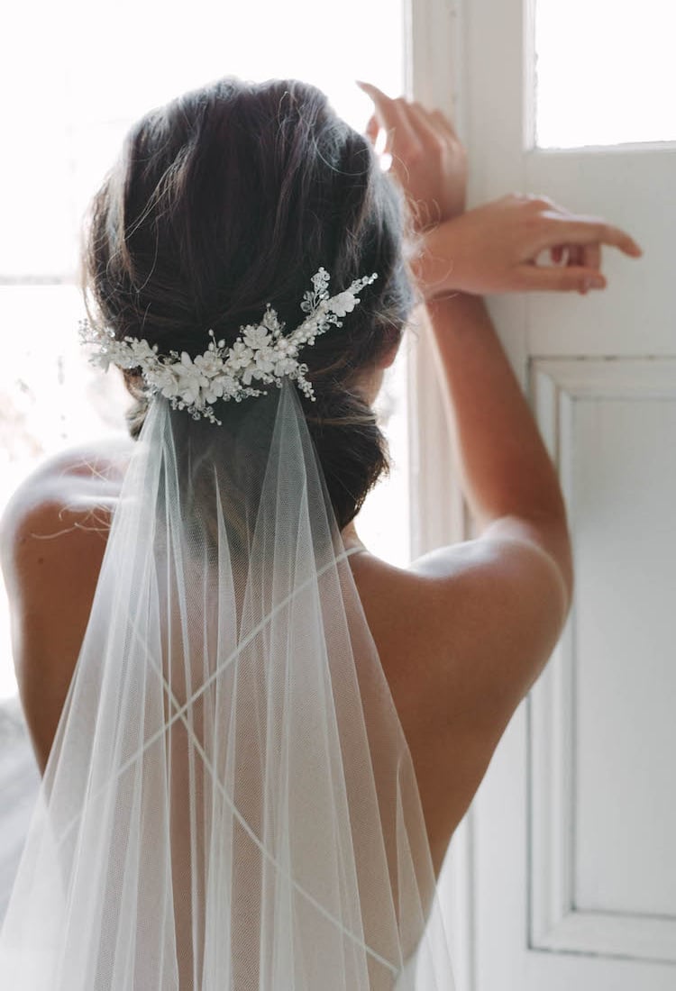 Low Bun With Veil And Floral Accessory Low Bun With Veil And Floral Accessory — Wedding Hair