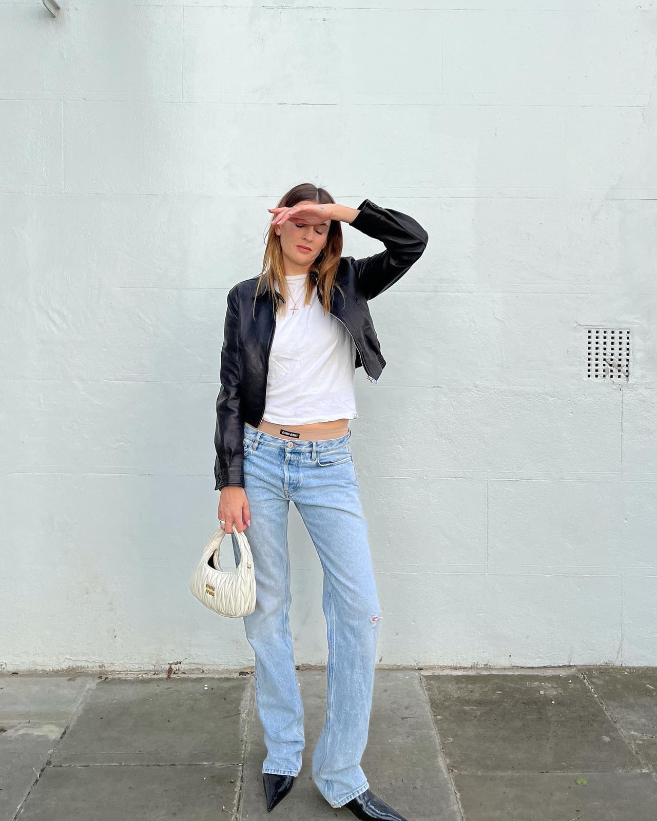 Black leather jacket over white t-shirt and low-rise jeans Black leather jacket over white t-shirt and low-rise jeans — Y2K Style